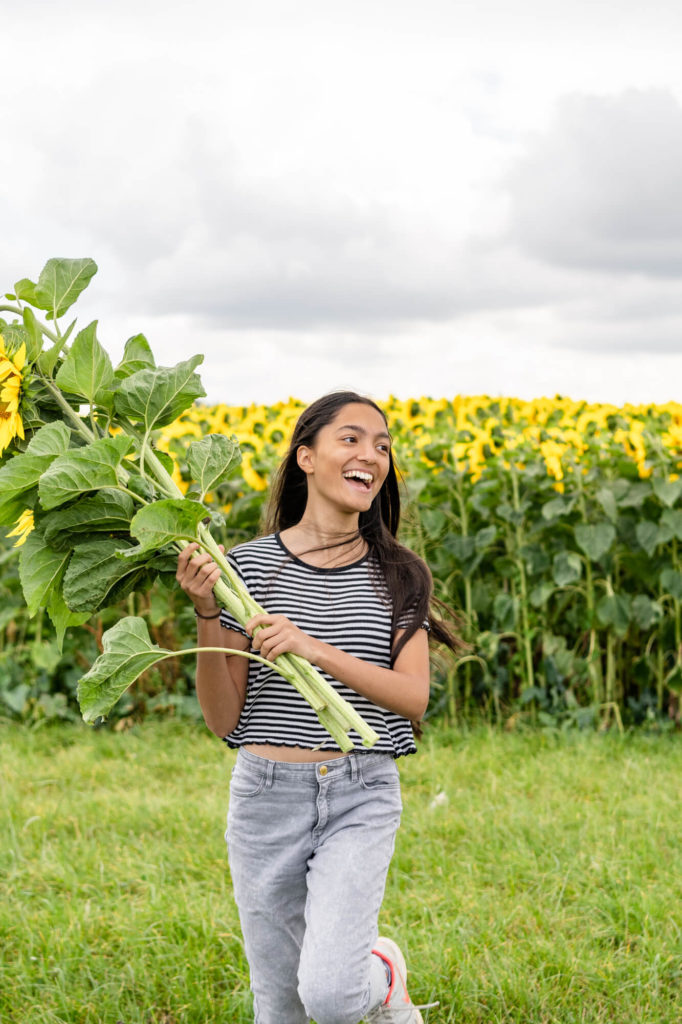 A girl running through a sunflower field