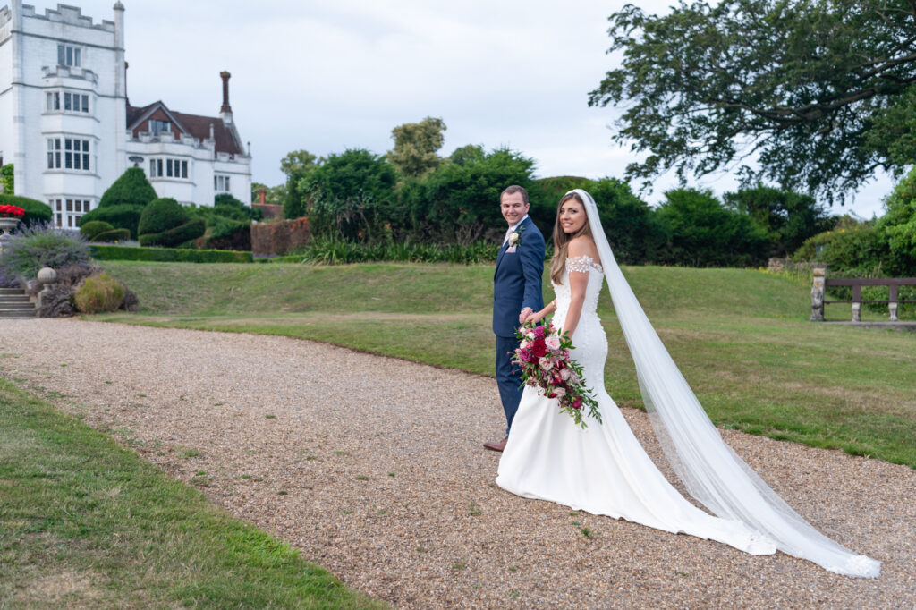 The couple standing outside of their Danesfield House wedding