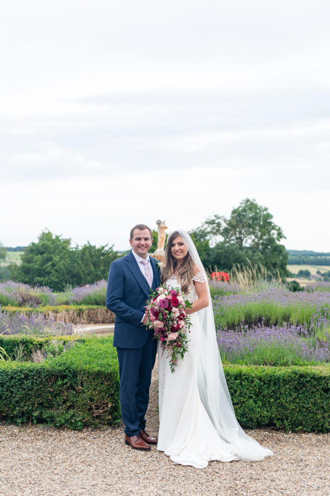 A couple outside of their Danesfield House wedding amongst the nature and the stunning grounds