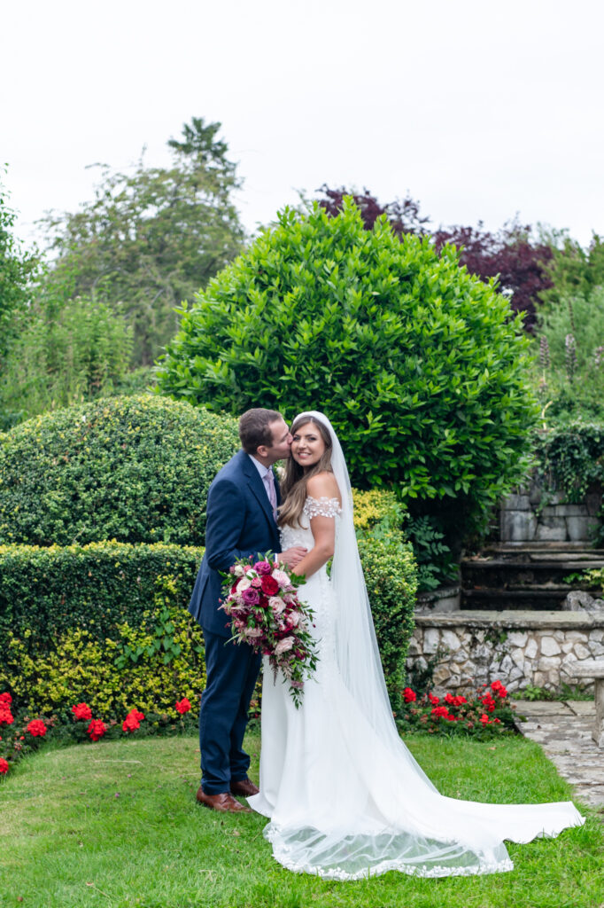 A couple outside of their Danesfield House wedding amongst the nature and the stunning grounds