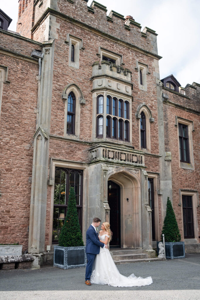 The couple standing outside of Rowton Castle wedding venue