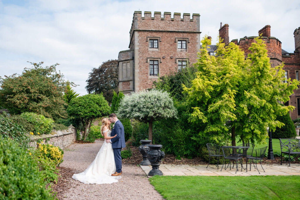 The couple standing outside of Rowton Castle wedding venue