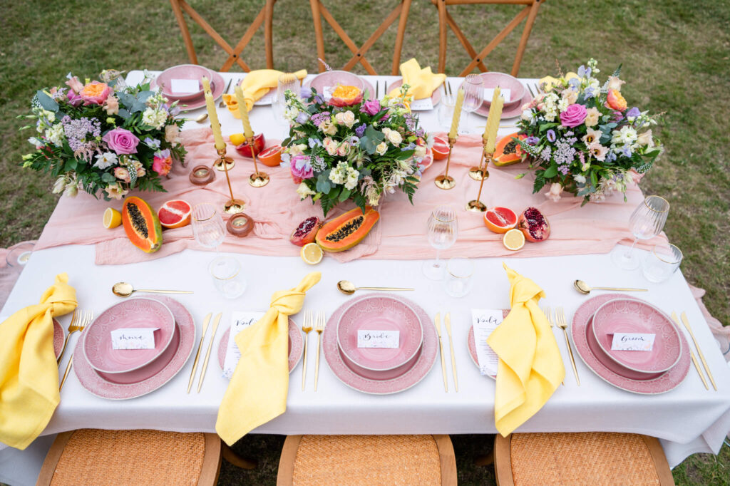 Outdoor summer wedding at Swanbourne House. Pink and yellow wedding colours