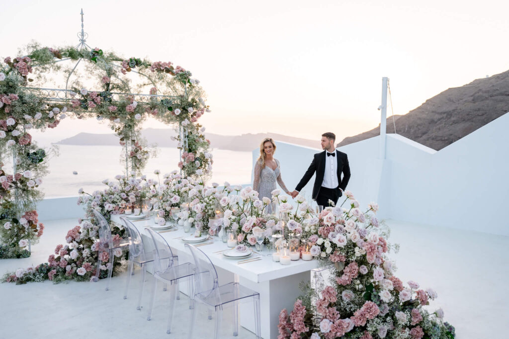 An outdoor destination wedding in Europe with the floral styling and the sea as a backdrop