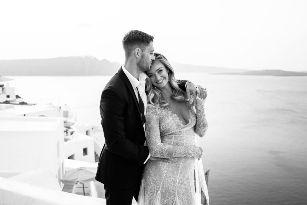 Couple portraits during a destination wedding in Europe with the sea as a backdrop