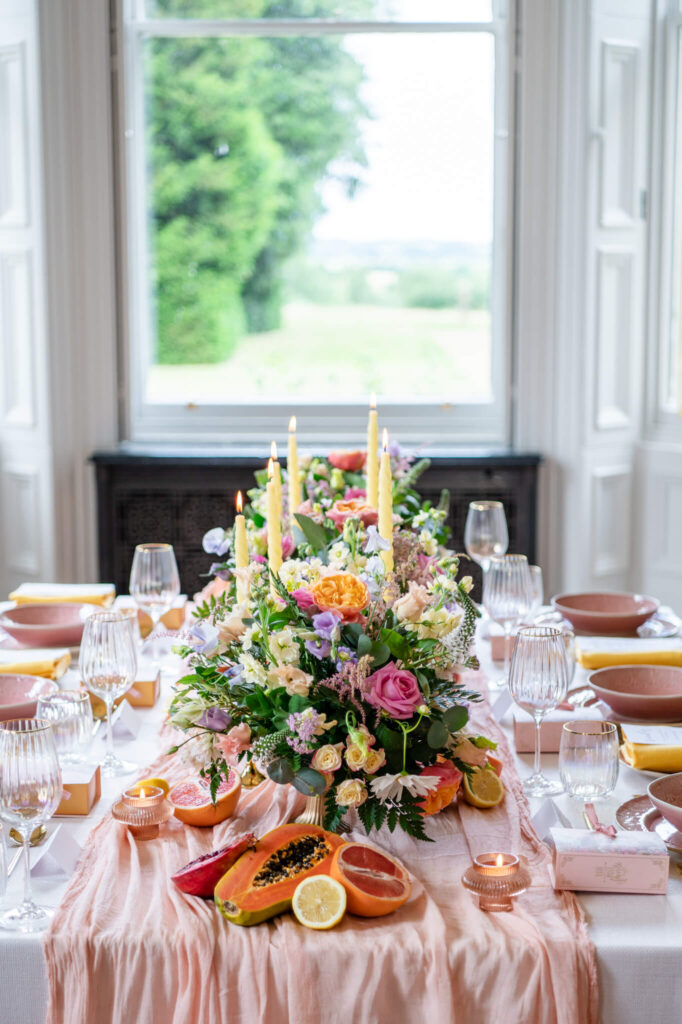 Summer wedding table inspiration with flowers and fruit. Swanbourne House Wedding Photographer Chloe Bolam