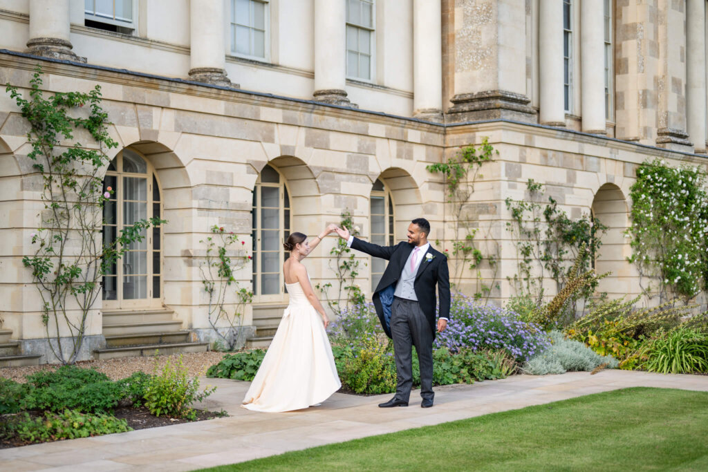 A newly married couple dancing in the gardens at Stowe House. Buckinghamshire wedding photographer Chloe Bolam Photography