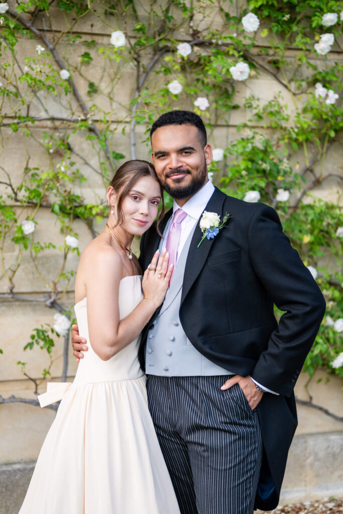 Portrait of a couple on their wedding at Stowe House by the rose gardens