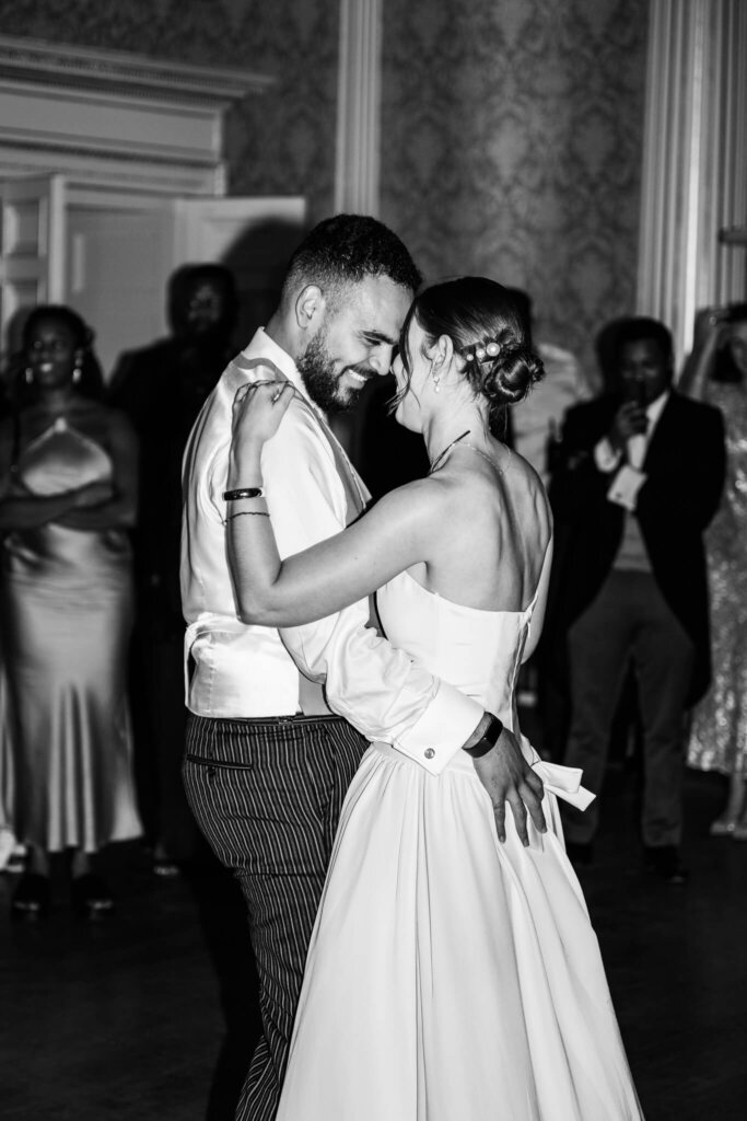 Black and white photo of a couple having their first dance at Stowe House, a luxury Buckinghamshire wedding venue