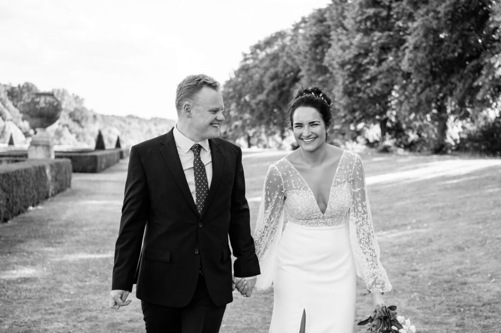 Black and white wedding portrait of a couple laughing on their wedding day. Cliveden House Hotel wedding photography