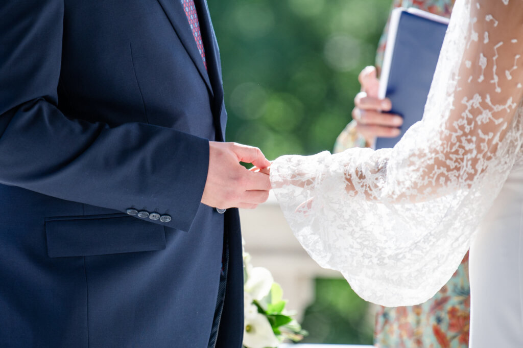 Outdoor wedding ceremony. Exchanging the rings